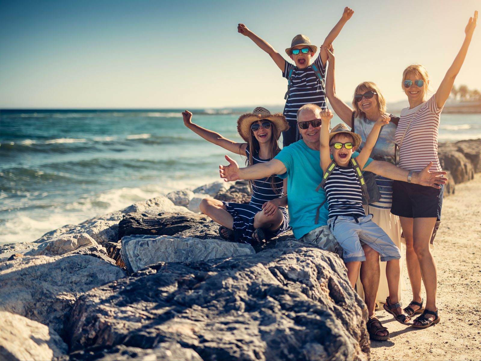 Multigenerational family enjoying time together by the ocean.