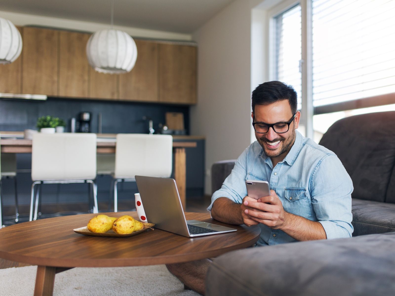 A person relaxing at home while looking at their phone
